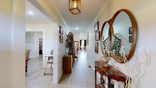 corridor featuring light hardwood / wood-style flooring and crown molding