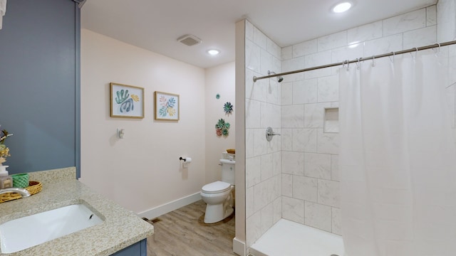 bathroom featuring hardwood / wood-style flooring, a shower with curtain, toilet, and vanity