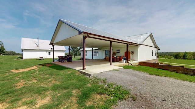 exterior space with a carport, a garage, and a front yard