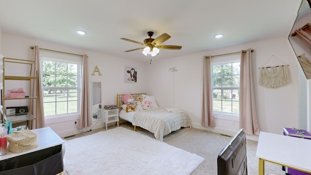 bedroom with multiple windows and ceiling fan