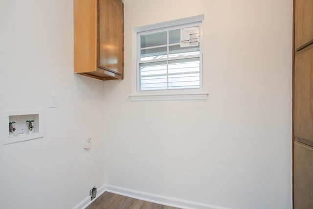 laundry room featuring hookup for a washing machine, wood-type flooring, and cabinets