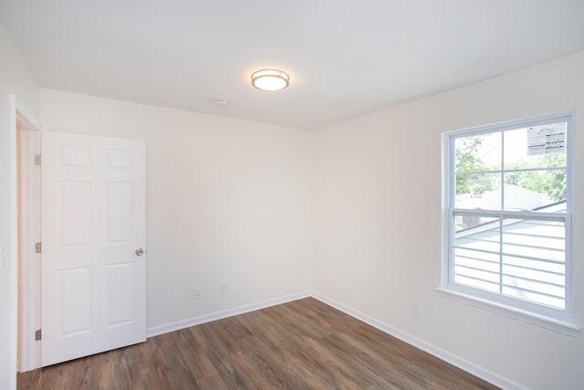 unfurnished room featuring dark hardwood / wood-style floors