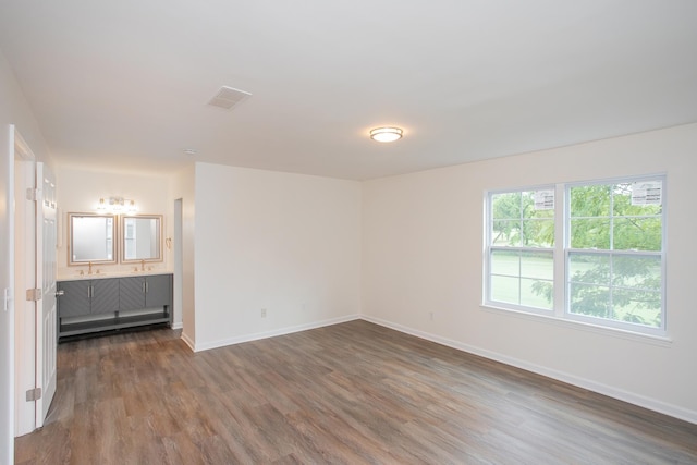 empty room with wood-type flooring