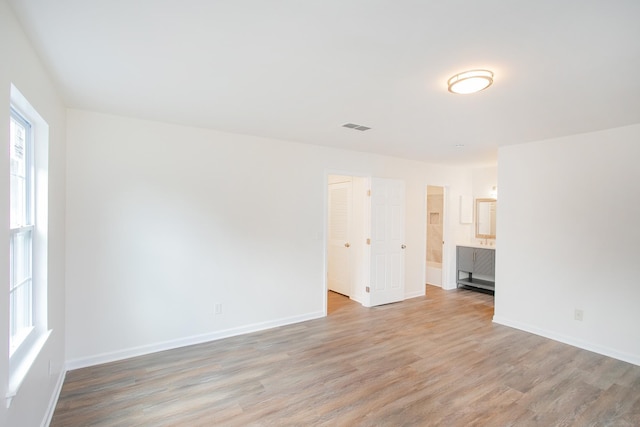 empty room with light hardwood / wood-style floors