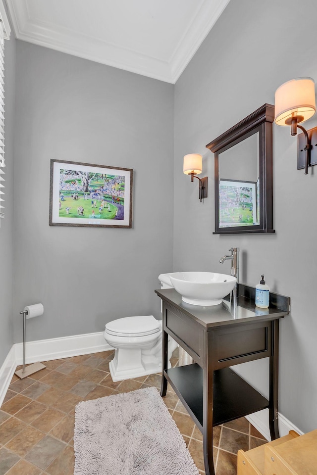 bathroom featuring ornamental molding, vanity, and toilet