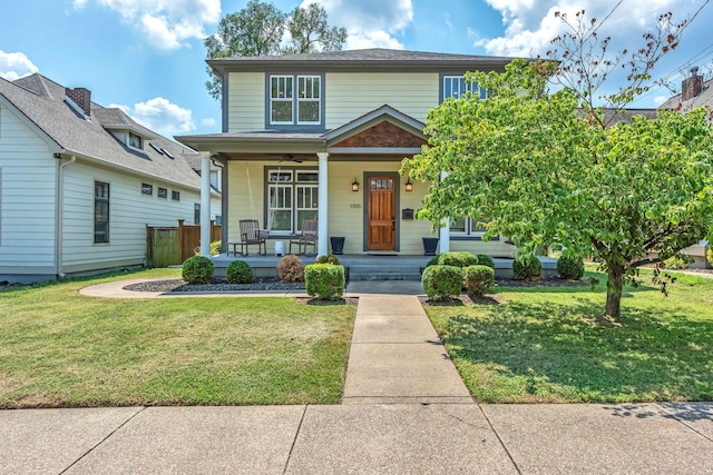 view of front of house with covered porch and a front lawn