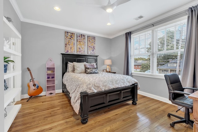 bedroom featuring crown molding, ceiling fan, and light hardwood / wood-style floors