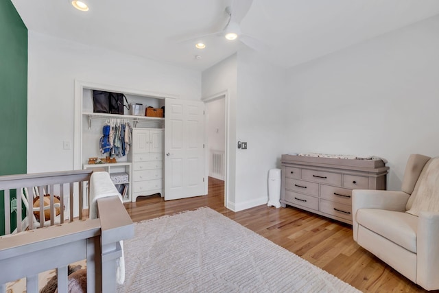 bedroom featuring ceiling fan, a closet, and light hardwood / wood-style flooring