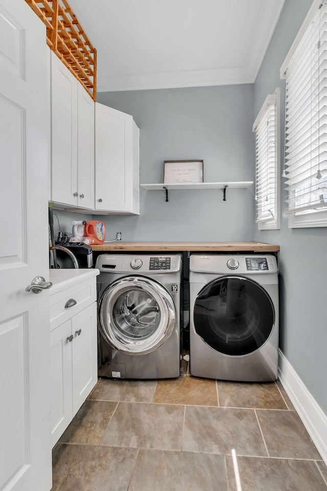 laundry room with cabinets, independent washer and dryer, and ornamental molding