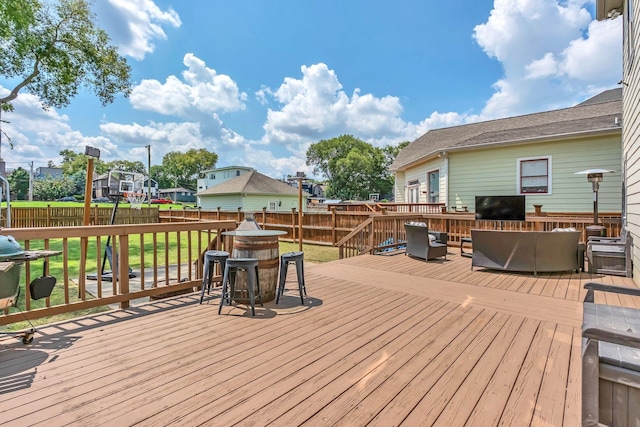 wooden deck featuring a lawn