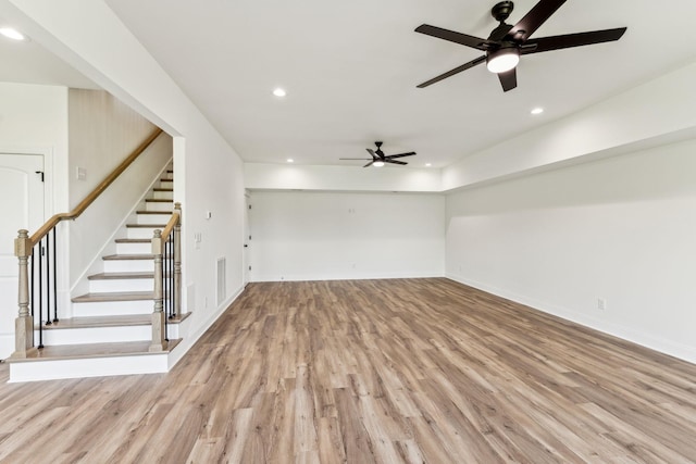 unfurnished living room with recessed lighting, visible vents, stairway, light wood-type flooring, and baseboards