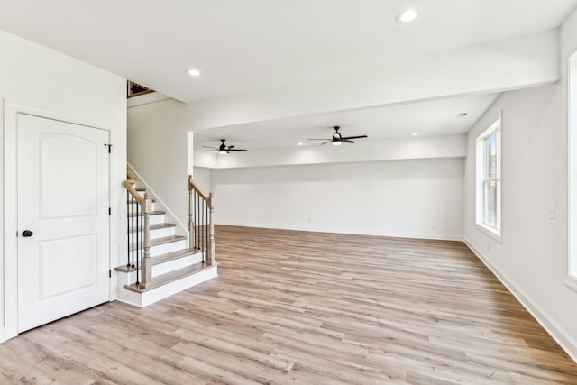 unfurnished living room with light hardwood / wood-style flooring and ceiling fan