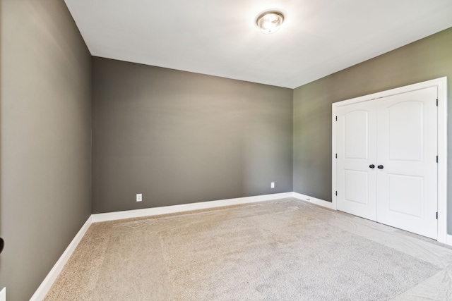 unfurnished bedroom with a closet and carpet flooring