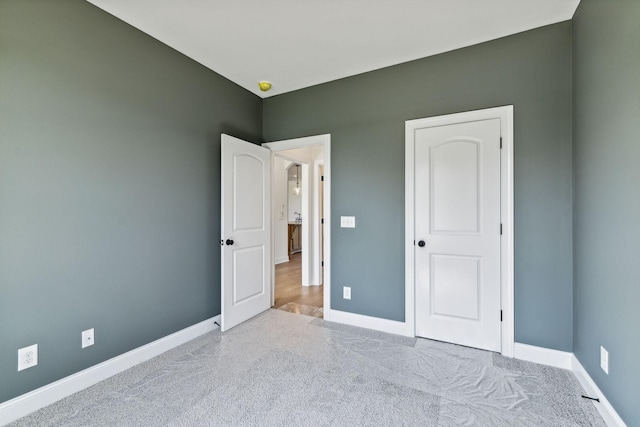 unfurnished bedroom with carpet and baseboards