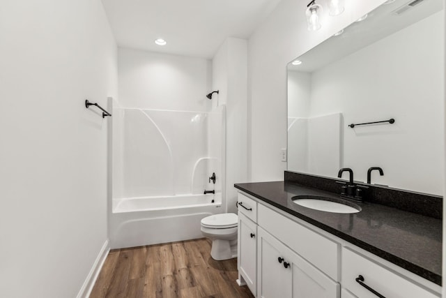 full bath featuring toilet, wood finished floors, visible vents, vanity, and shower / bathing tub combination