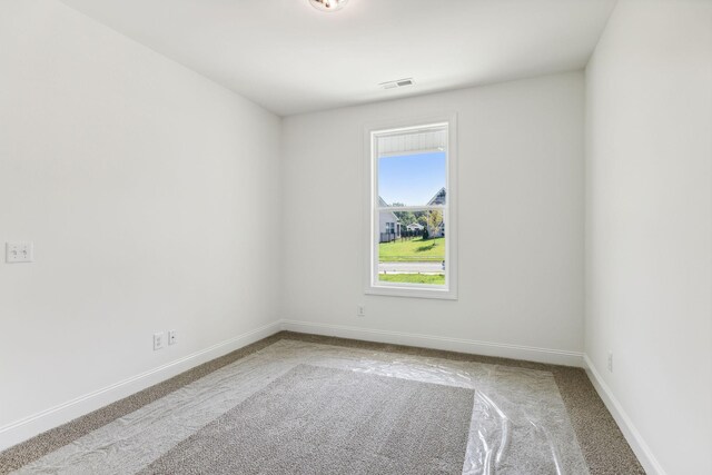 spare room with light colored carpet