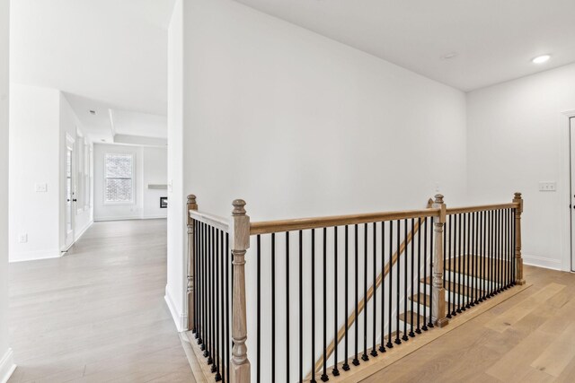 hallway with light hardwood / wood-style floors