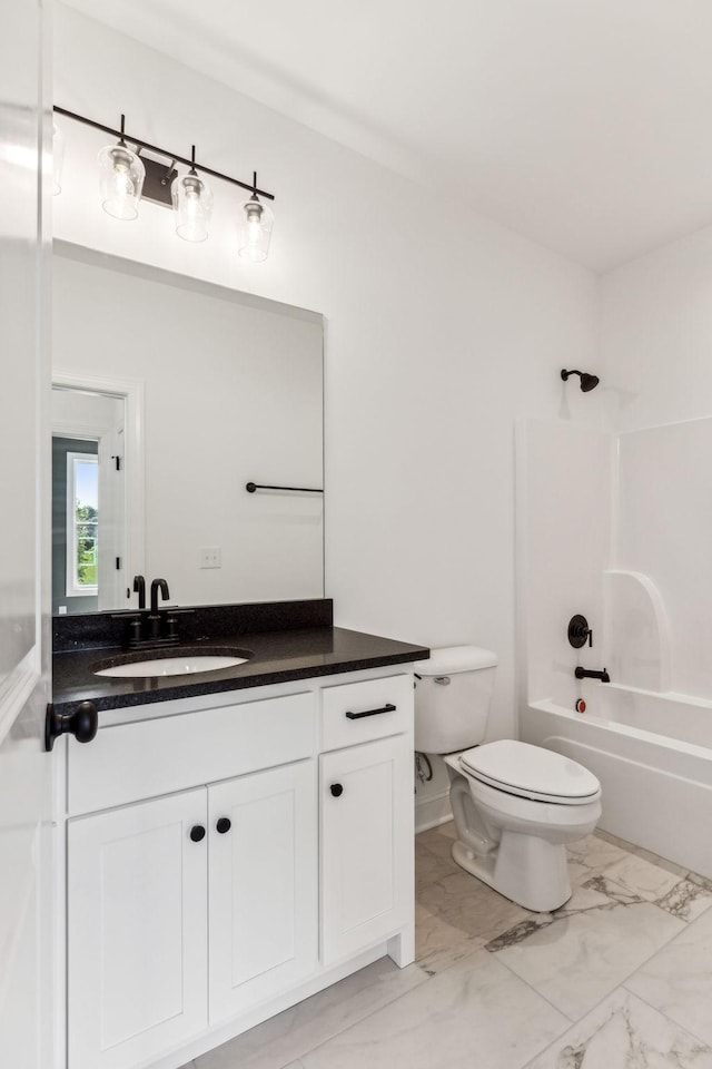 full bathroom featuring marble finish floor, tub / shower combination, vanity, and toilet