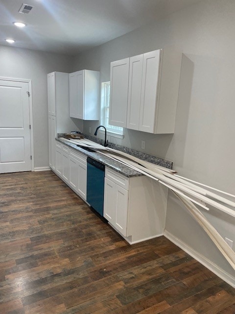 kitchen featuring black dishwasher, sink, dark hardwood / wood-style floors, and white cabinets