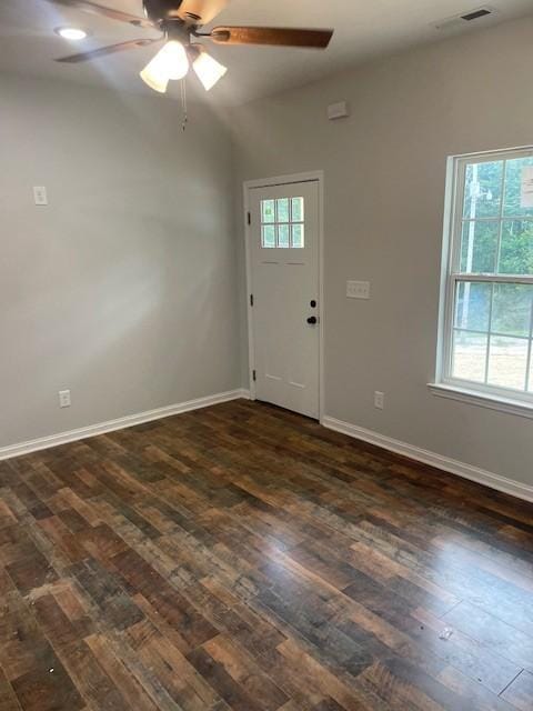 foyer entrance with dark hardwood / wood-style flooring and ceiling fan