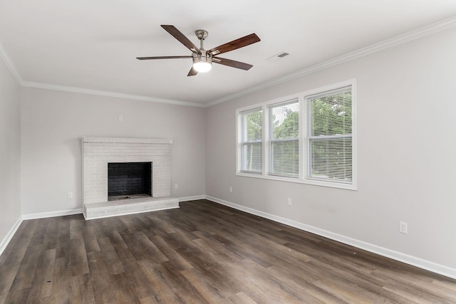 unfurnished living room featuring ornamental molding, a brick fireplace, ceiling fan, and dark hardwood / wood-style flooring