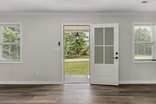 doorway to outside with ornamental molding and hardwood / wood-style floors