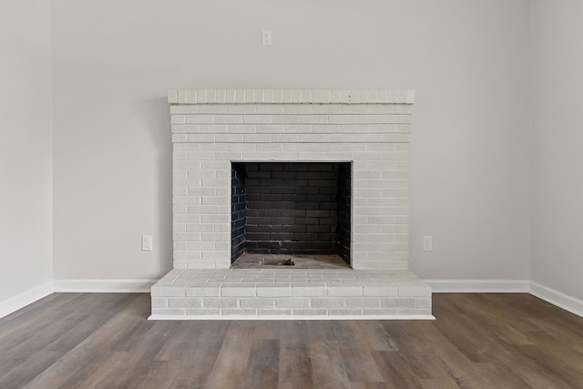 interior details featuring a fireplace and wood-type flooring