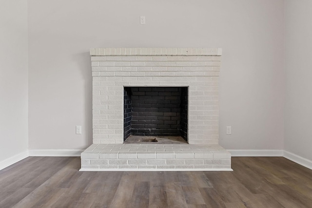 interior details with hardwood / wood-style floors and a brick fireplace