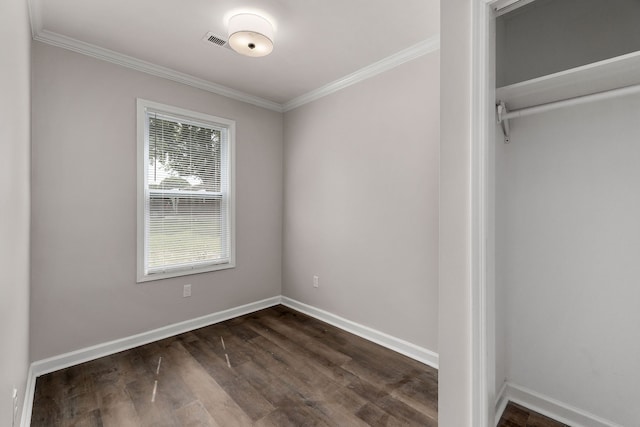 unfurnished bedroom with ornamental molding, a closet, and hardwood / wood-style floors