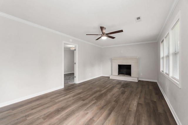 unfurnished living room featuring crown molding, ceiling fan, dark hardwood / wood-style floors, and a brick fireplace