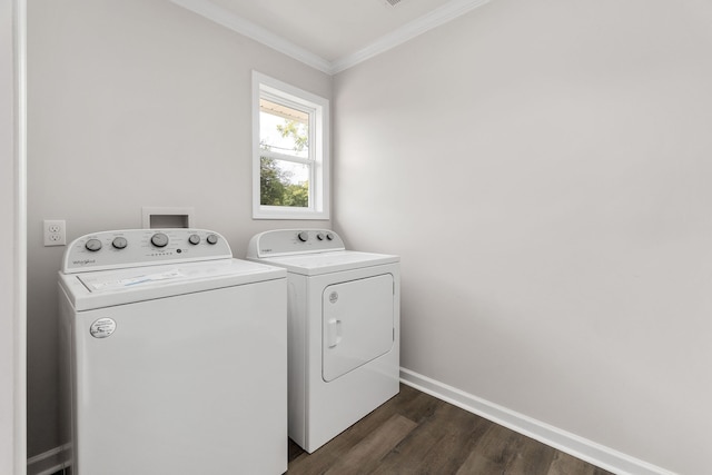 laundry area featuring dark hardwood / wood-style floors, separate washer and dryer, and crown molding