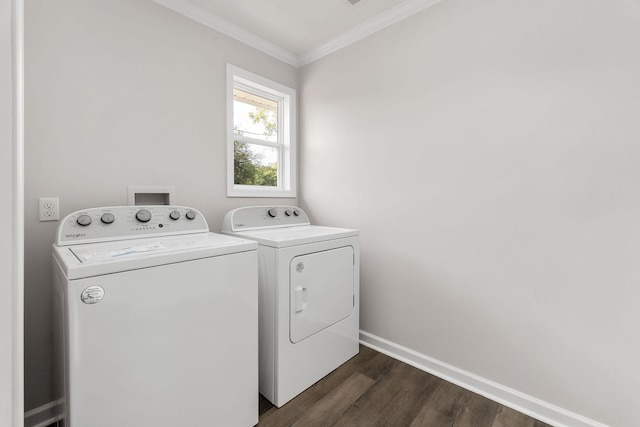 laundry area with ornamental molding, dark hardwood / wood-style flooring, and washer and clothes dryer