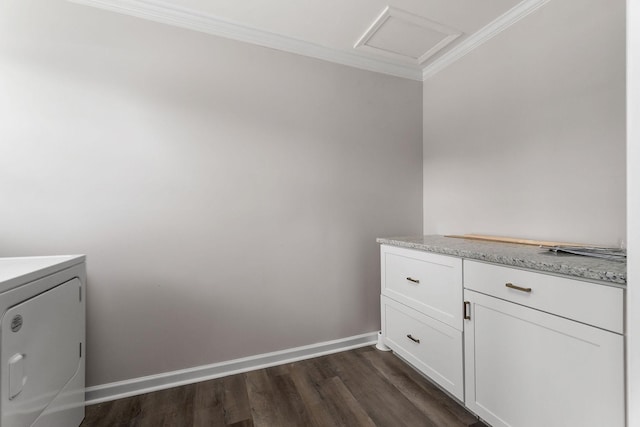 laundry room featuring crown molding, cabinets, washer / clothes dryer, and dark wood-type flooring