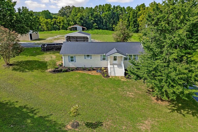 view of front of property with a shed and a front yard