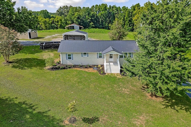 back of house with a lawn