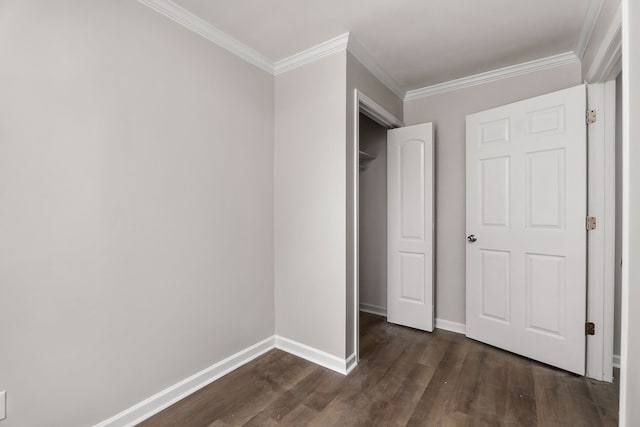 unfurnished bedroom with crown molding, dark hardwood / wood-style flooring, and a closet