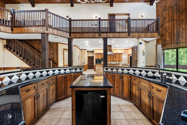 kitchen with a high ceiling, tasteful backsplash, and a kitchen island