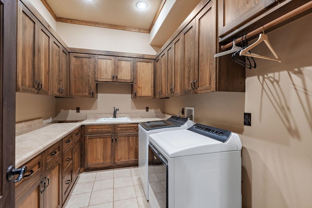 clothes washing area featuring cabinets, separate washer and dryer, sink, and light tile patterned floors