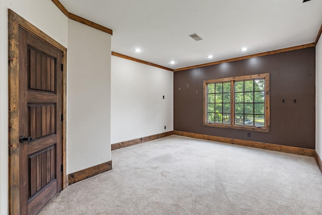 unfurnished room featuring crown molding and light colored carpet