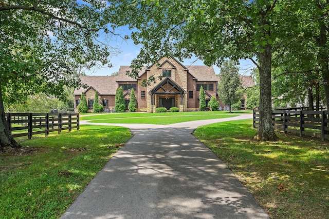 english style home with a front yard