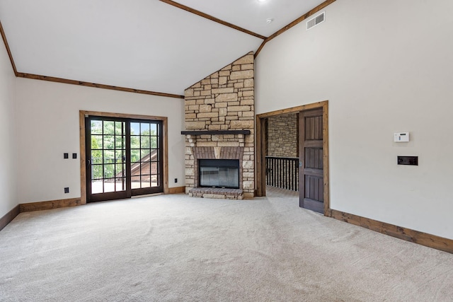 unfurnished living room featuring ornamental molding, carpet flooring, high vaulted ceiling, and a stone fireplace