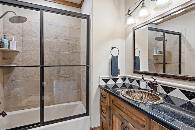 bathroom with bath / shower combo with glass door and vanity