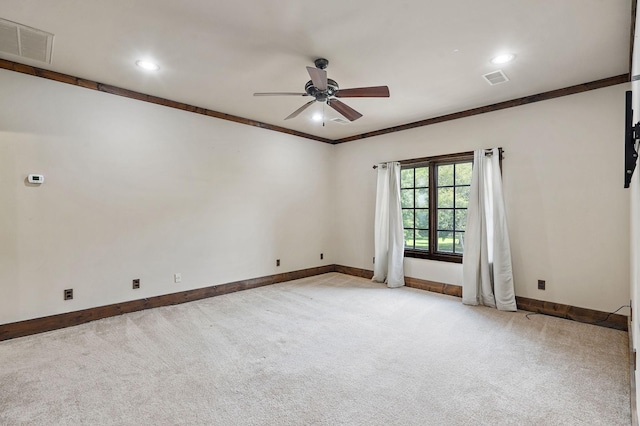 carpeted empty room with ceiling fan and ornamental molding