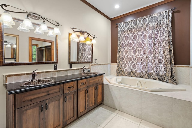 bathroom featuring tile patterned flooring, vanity, tiled tub, and crown molding