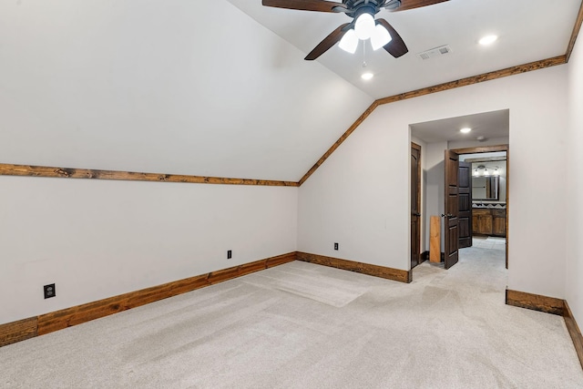 bonus room with lofted ceiling, light carpet, and ceiling fan