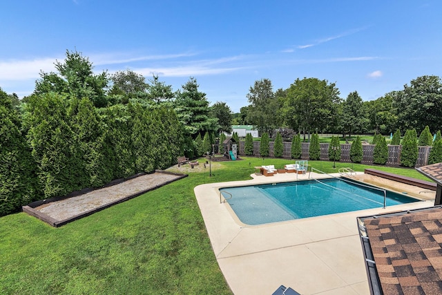 view of swimming pool featuring a patio and a lawn