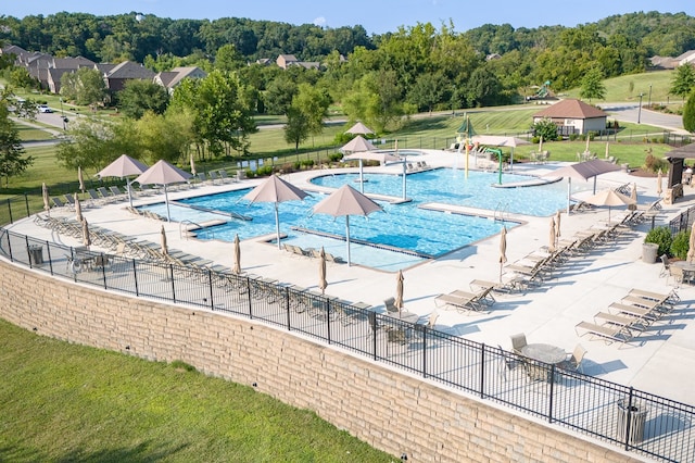 view of pool featuring a patio and a yard