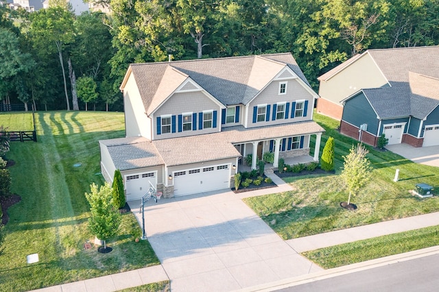 view of front of property featuring a garage and a front lawn