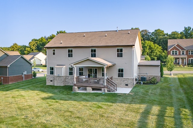 back of property with central AC unit, a lawn, and a deck