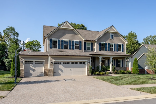 craftsman inspired home featuring a garage, covered porch, and a front lawn